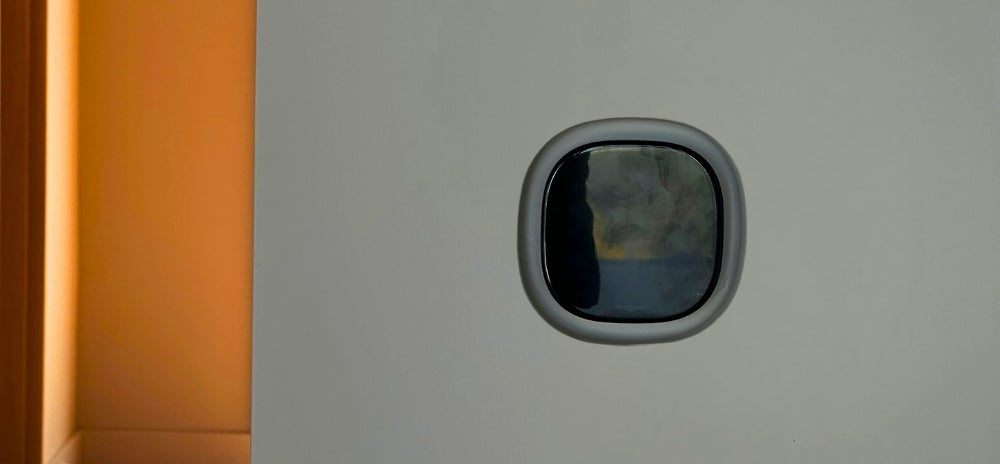 Ecobee Smart Thermostat Premium recessed into a wall with a flush in-wall mount, shown against a minimalist interior background.