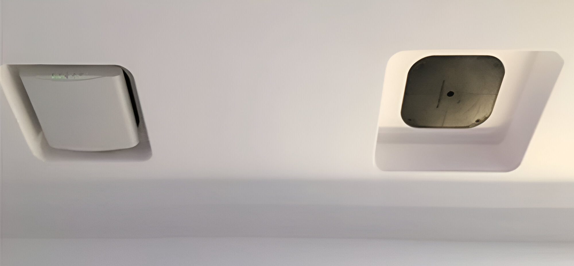 Ruckus access points recessed into SeeLess ceiling mounts, featuring a smooth white finish and flush architectural design.