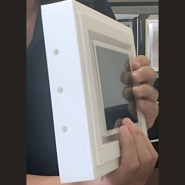 Interior shot showing Crestron 7″ touch panel flush aligned in drywall via SLA‑TPCT7‑375 platform.