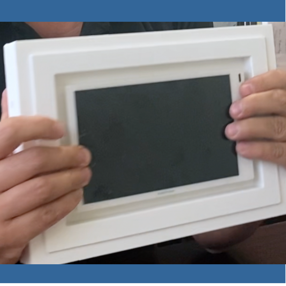 Close‑up of Crestron 7″ panel fitted into SLA‑TPCT7‑375 gypsum mount — exact two‑gang opening and precision fit.