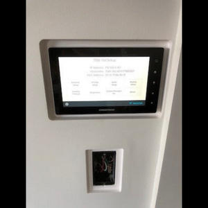 In‑wall SLD‑TPS‑500 two‑gang back box platform showing Crestron touch panel — paintable gypsum with ½″ reveal.