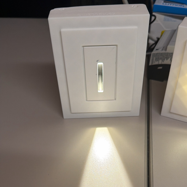 sl-3005-062-rectangular-step-light-desk-mockup-2.png Alt text: White rectangular SeeLess step light SL-3005-062 with 1/16" reveal, glowing warm light, shown on a desk mockup