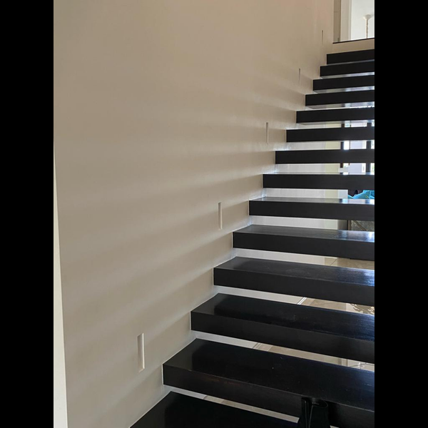 Modern staircase with unlit SeeLess step lights mounts.