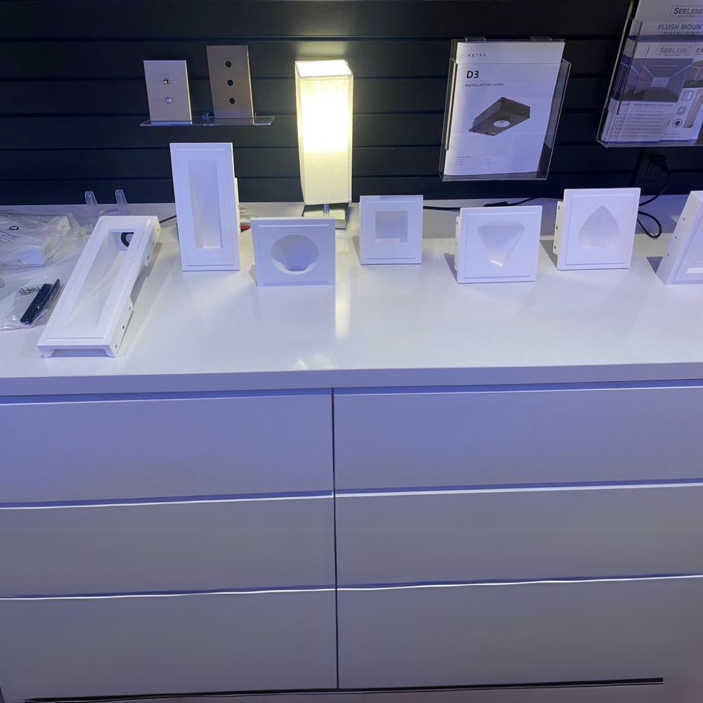 Display of gypsum step light flush mounts variety on a white countertop with a dark background