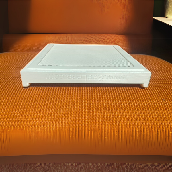 Angled view of Theory IC6 square speaker in SL-SICS6S-062 plaster mount, blending into the mount